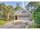 Charming one-story home with brick facade, lush landscaping, and an expansive driveway at 347 Prestwick Ct, Summerville, SC 29483