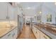Open kitchen featuring white cabinets, granite counters, stainless appliances, and hardwood flooring at 347 Prestwick Ct, Summerville, SC 29483