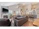 Cozy living room with a fireplace, comfortable seating, open floor plan, and a view of the kitchen at 347 Prestwick Ct, Summerville, SC 29483