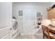 Functional mudroom with a door, laundry machine, cabinet, and a desk at 347 Prestwick Ct, Summerville, SC 29483
