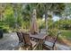 Charming backyard patio with metal table and chairs under a decorative umbrella at 347 Prestwick Ct, Summerville, SC 29483