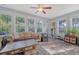 Bright sunroom with many windows, a ceiling fan, and comfortable seating with stylish flooring at 347 Prestwick Ct, Summerville, SC 29483
