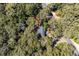 Aerial view of a home nestled in lush greenery, featuring a dark roof and surrounded by mature trees at 3510 Deer Run Rd, Seabrook Island, SC 29455