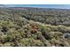 Aerial view of home nestled among mature trees in a wooded, scenic neighborhood near ocean and golf course at 3510 Deer Run Rd, Seabrook Island, SC 29455
