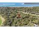 Aerial view displaying wooded home near golf course, sandy beach and ocean, emphasizing its natural setting at 3510 Deer Run Rd, Seabrook Island, SC 29455
