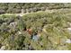 Aerial view highlighting a property with a dark roof surrounded by trees, situated near a golf course at 3510 Deer Run Rd, Seabrook Island, SC 29455