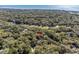 Aerial view of property surrounded by a canopy of trees, a pond, a golf course, and ocean view at 3510 Deer Run Rd, Seabrook Island, SC 29455