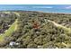 Aerial view of home nestled among mature trees in a wooded, scenic neighborhood near the ocean and a golf course at 3510 Deer Run Rd, Seabrook Island, SC 29455