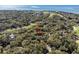 Aerial view of home nestled among mature trees in a wooded, scenic neighborhood near the ocean and golf course at 3510 Deer Run Rd, Seabrook Island, SC 29455