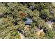 Aerial view of a house surrounded by dense trees, showing the roof and the natural landscape at 3510 Deer Run Rd, Seabrook Island, SC 29455