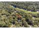 Aerial view of a property surrounded by trees, a pond, and a golf course in a serene, wooded environment at 3510 Deer Run Rd, Seabrook Island, SC 29455