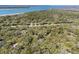Aerial view displaying wooded home near golf course, sandy beach and a bay, emphasizing its natural setting at 3510 Deer Run Rd, Seabrook Island, SC 29455
