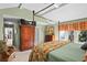 Bright main bedroom featuring hardwood floors, four-poster bed, and ample closet space at 3510 Deer Run Rd, Seabrook Island, SC 29455