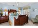 Tranquil bedroom with blue walls, wooden bed frame, and natural light through the window at 3510 Deer Run Rd, Seabrook Island, SC 29455