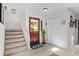 The bright entryway features a staircase, a coat closet, and a decorative rug at 3510 Deer Run Rd, Seabrook Island, SC 29455