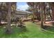 A wide shot of the attractive two-story home with a large yard, deck, and surrounded by lush greenery at 3510 Deer Run Rd, Seabrook Island, SC 29455