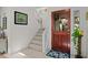 Inviting foyer with dutch door, tiled floors, staircase, and plant stand at 3510 Deer Run Rd, Seabrook Island, SC 29455