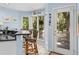 Eat-in kitchen features black countertops, wicker chairs and a door leading to the outdoors at 3510 Deer Run Rd, Seabrook Island, SC 29455