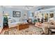 Cozy living room features hardwood floors, nautical accents, and an adjoining sunroom at 3510 Deer Run Rd, Seabrook Island, SC 29455
