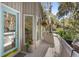 Inviting porch with a blue door, flower boxes, and a hanging plant at 3510 Deer Run Rd, Seabrook Island, SC 29455