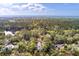 Aerial view showcases a community surrounded by trees and waterfront access and ocean in the distance at 37 Marsh Edge, Kiawah Island, SC 29455