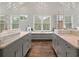 Beautiful primary bathroom with dual vanities, a soaking tub, and lots of natural light from the window at 37 Marsh Edge, Kiawah Island, SC 29455