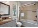 Well-lit bathroom featuring granite countertop vanity and glass enclosed tub and shower at 37 Marsh Edge, Kiawah Island, SC 29455