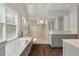 Bright and airy bathroom featuring a large soaking tub, glass-enclosed shower, and modern fixtures at 37 Marsh Edge, Kiawah Island, SC 29455