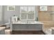 Tranquil bathroom with a large soaking tub, a shower, and a bright window, creating a spa-like experience at 37 Marsh Edge, Kiawah Island, SC 29455