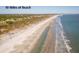 A beautiful aerial view of a beach, with sandy shores and clear blue ocean waters at 37 Marsh Edge, Kiawah Island, SC 29455