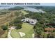Aerial view of the clubhouse with tennis courts, a pond, and lush green surroundings at 37 Marsh Edge, Kiawah Island, SC 29455