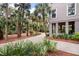 Beautifully landscaped property with lush greenery, palm trees, and a winding driveway at 37 Marsh Edge, Kiawah Island, SC 29455