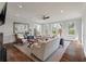 Bright living room features hardwood floors, fireplace, ceiling fan, and multiple windows at 37 Marsh Edge, Kiawah Island, SC 29455