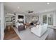 Spacious living room features hardwood floors, fireplace, ceiling fan, and bright, natural light at 37 Marsh Edge, Kiawah Island, SC 29455