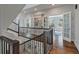 Open staircase with dark wood railings and trim and open floorplan with French doors at 37 Marsh Edge, Kiawah Island, SC 29455