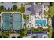 Overhead view of tennis courts next to the swimming pool and Sports Pavilion, surrounded by lush greenery at 37 Marsh Edge, Kiawah Island, SC 29455