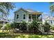 Backyard of a house with a screened porch and plants near the elevated porch at 3717 Tip Ln, Mount Pleasant, SC 29466