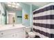 Bright bathroom featuring a vanity with a mirror and a shower with a striped curtain at 3717 Tip Ln, Mount Pleasant, SC 29466