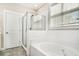 Bright bathroom featuring a glass shower, white subway tile, soaking tub and a large window at 3717 Tip Ln, Mount Pleasant, SC 29466