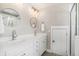 Bright bathroom featuring a dual sink vanity with round mirrors and a glass shower at 3717 Tip Ln, Mount Pleasant, SC 29466