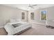 Bright bedroom with three windows, a ceiling fan, and neutral carpet flooring at 3717 Tip Ln, Mount Pleasant, SC 29466