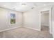 Well-lit bedroom featuring neutral walls, carpeted floor, window, and access to another room at 3717 Tip Ln, Mount Pleasant, SC 29466