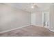 A cozy bedroom with carpet, window, ceiling fan, and a bathroom adjacent to it at 3717 Tip Ln, Mount Pleasant, SC 29466
