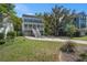 Charming two-story home features a spacious porch, light-colored siding, dark shutters, and a long driveway at 3717 Tip Ln, Mount Pleasant, SC 29466