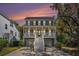 Charming two-story home features a spacious porch, light-colored siding, dark shutters, and well-manicured landscaping at 3717 Tip Ln, Mount Pleasant, SC 29466