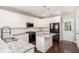 Modern kitchen with white cabinets, granite countertops, stainless steel appliances, and a center island at 3717 Tip Ln, Mount Pleasant, SC 29466