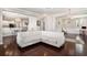 Spacious living room with a white couch, dark hardwood floors, and an open layout to the kitchen and dining area at 3717 Tip Ln, Mount Pleasant, SC 29466