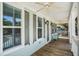 The spacious porch boasts white columns, railings, and ceiling fans, perfect for outdoor living at 3717 Tip Ln, Mount Pleasant, SC 29466