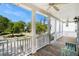 The spacious porch boasts white columns, railings, and ceiling fans, perfect for outdoor living at 3717 Tip Ln, Mount Pleasant, SC 29466