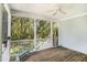 Inviting screened porch with wooden floors and serene views of the surrounding greenery at 3717 Tip Ln, Mount Pleasant, SC 29466